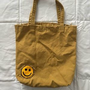 Urban Outfitters Ripped Smiley Face Tote Bag
